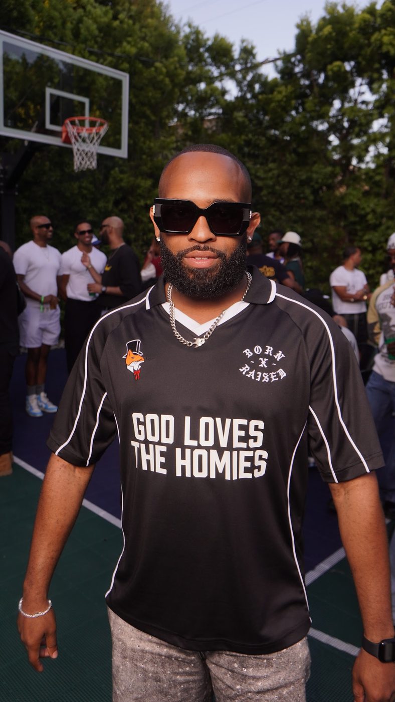Trevor Queen on a community basketball court in a God Loves The Homies jersey