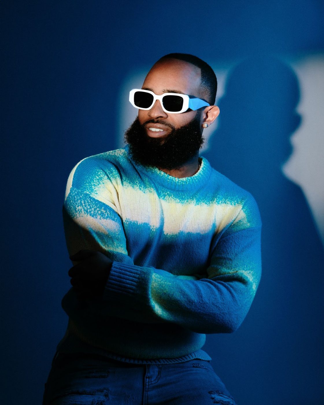 Trevor Queen in a blue gradient sweater under blue light