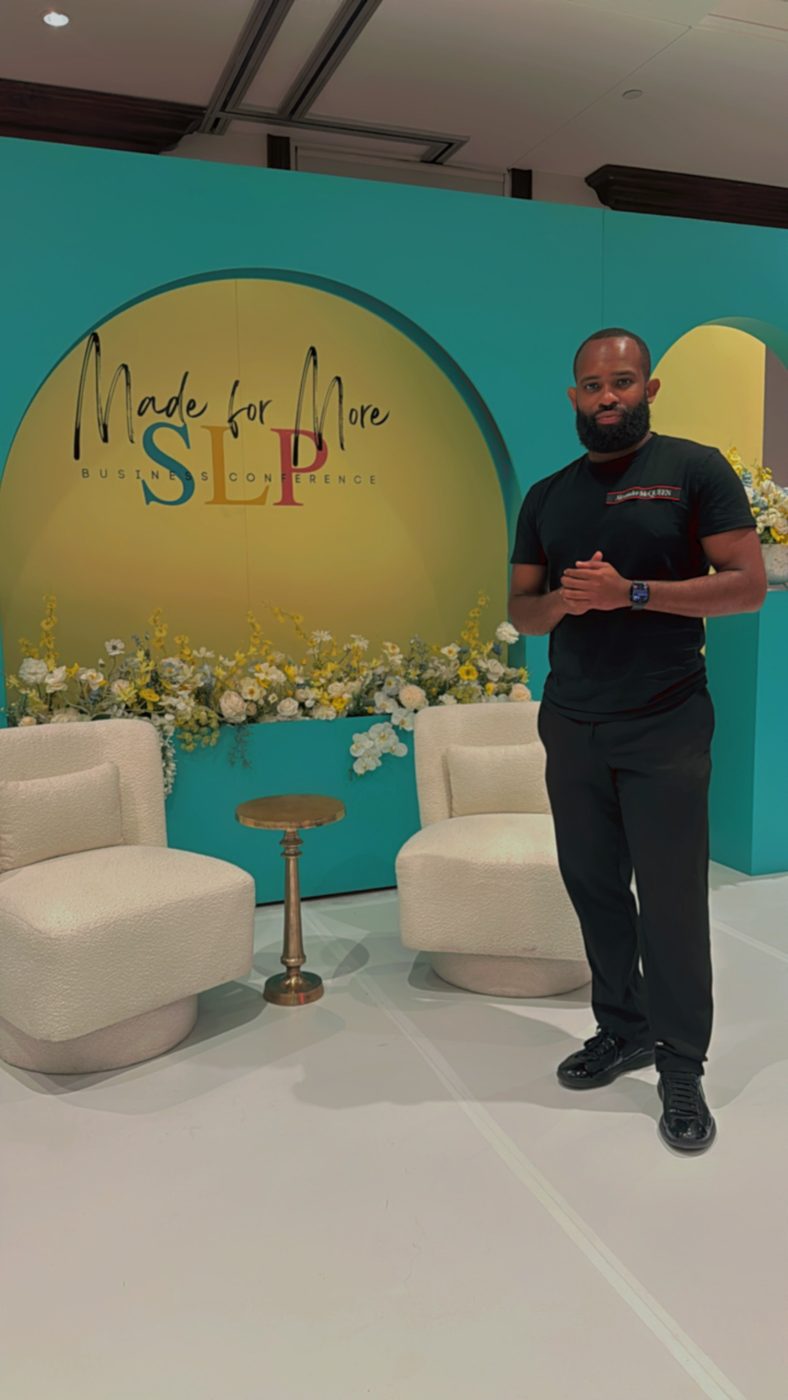 A built event set with floral staging and custom signage
